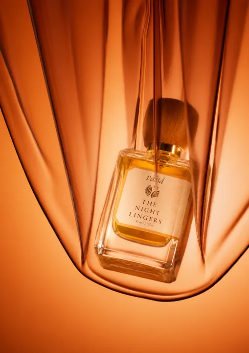 The Night Lingers beneath a sheer amber drape